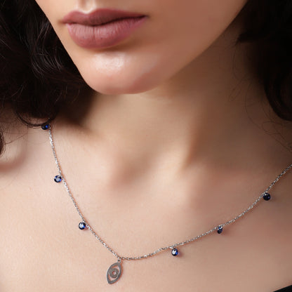 Sapphire Whispers: A delicate silver necklace with vibrant blue accents