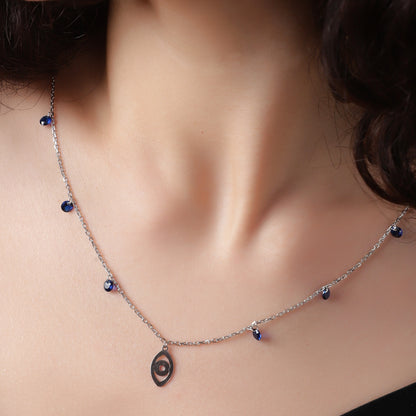 Sapphire Whispers: A delicate silver necklace with vibrant blue accents