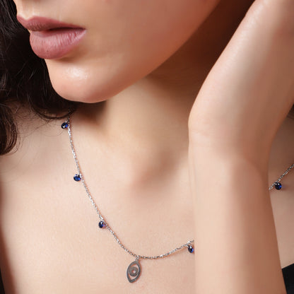 Sapphire Whispers: A delicate silver necklace with vibrant blue accents