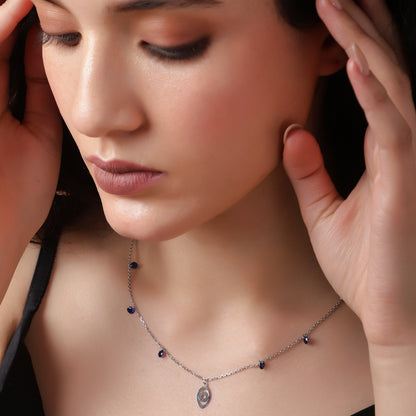 Sapphire Whispers: A delicate silver necklace with vibrant blue accents